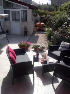 a patio with two chairs and a table with at Apartman Mir in Kaštela