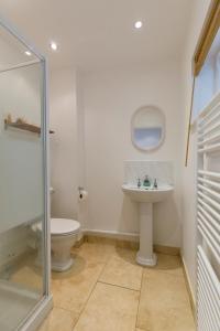 a bathroom with a toilet and a sink at The Haven in Portreath