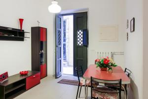 a kitchen and dining room with a red table and chairs at Taormina Sunny Experience in Taormina