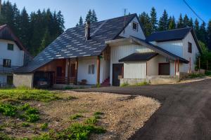 a house with solar panels on the roof at Guest house Jezera in Žabljak