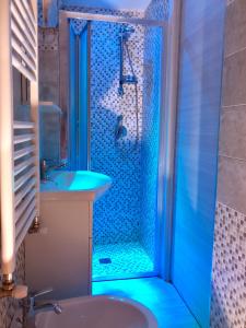 a bathroom with a shower with a sink and a toilet at Zia Paoletta in Martina Franca