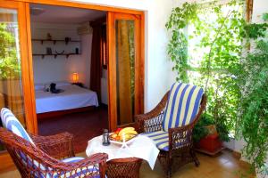 a patio with two chairs and a table and a bed at Monten in Sveti Stefan
