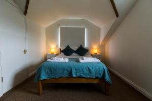 a bedroom with a bed with two pillows at The Haven in Portreath