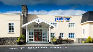 a white building with a park inn sign on it at Park Inn by Radisson Shannon Airport in Shannon