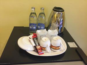 a table with a plate of food and two bottles of soda at PPS Home in Surin