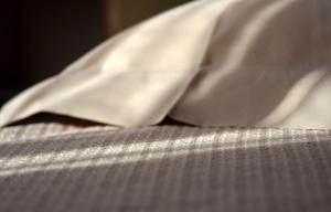 a close up of a white shirt on a bed at Ai Pesci Room Rental in Riomaggiore