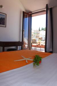 a clock on top of a bed in a room at Monten in Sveti Stefan