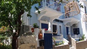 a blue and white building with a blue door at Studios Iris in Pythagoreio