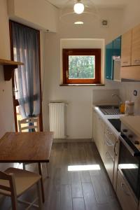 a small kitchen with a table and a window at Seaview Apartment Monterosso, Cinque Terre in Monterosso al Mare