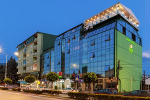 a large glass building with lights on top of it at Green Center Gili in Gostivar