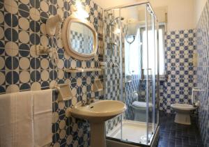 a bathroom with a sink and a toilet and a mirror at Hotel Sole in Nocera Inferiore