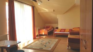 a living room with two beds and a window at Willa Marand in Jastarnia