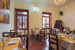 a restaurant with tables and chairs and a chandelier at Hotel Santa Lucia Boutique Spa in Bogotá