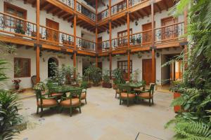 a patio with tables and chairs in a building at Hotel Santa Lucia Boutique Spa in Bogotá