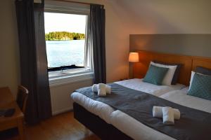 Un pat sau paturi într-o cameră la Håveruds hotell och konferens