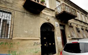 - un bâtiment avec une porte noire et un balcon dans l'établissement Old Arsena Apartments, à Tbilissi