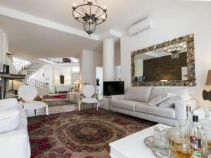 a living room with a couch and a mirror at Stella Moresca Luxury Villa in Calasetta