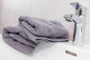 a towel sitting on a sink next to a faucet at Ferienwohnungen Marietta in Reit im Winkl +27 photos