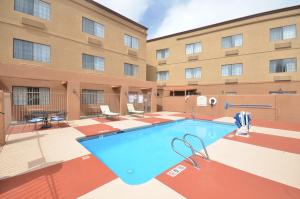 a swimming pool in front of a building at Ramada by Wyndham Santa Fe in Santa Fe