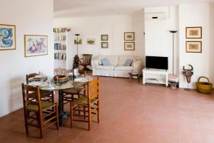 a living room with a table and a couch at Casa la Mimosa in Leuca