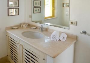 a bathroom with a sink and a mirror at Casa la Mimosa in Leuca +26 photos
