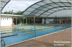 a swimming pool in a building with a large swimming pool at Can Pinyana in Torreblanca