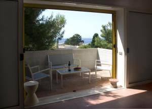 an open door to a patio with a table and chairs at Casa la Mimosa in Leuca