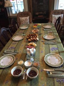 a table with plates and bowls of food on it at Lantana House in Rockport