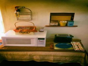 a microwave sitting on top of a table at Cozy Muir Cottage - In Town - Pet Friendly in Lone Pine +6 photos