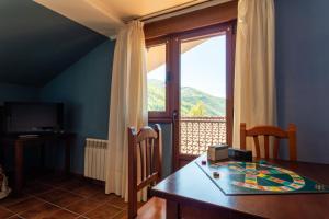a dining room with a table and a window at Peña Pandos 2 Estrellas in Felechosa +33 photos