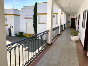a corridor of a building with a balcony at Hotel Roma in Oaxaca City