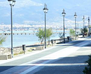 a street with street lights next to the water at Hotel Avra in Perea