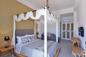 a bedroom with a white bed with a canopy at Aqua Marine in Neos Marmaras