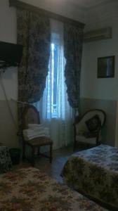 En eller flere senger på et rom på Hotel Stadler 2