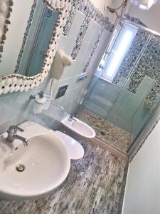 a bathroom with a sink and a mirror at Versomare in Polignano a Mare