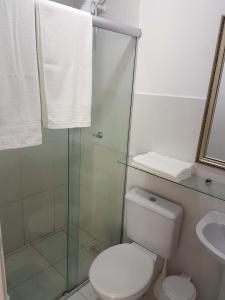a bathroom with a toilet and a glass shower at Apartamento no Dalas Park Residencial in Campina Grande