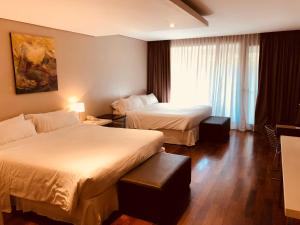Кровать или кровати в номере San Isidro Plaza Hotel