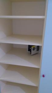 a white book shelf with a radio on it at Cozy and modern apartment (provence) in Saint Petersburg