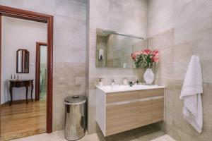 a bathroom with a sink and a mirror at City Apartments in Budva