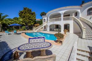 a large white house with a swimming pool at La Perla - sea view villa with private pool in Moraira in Moraira