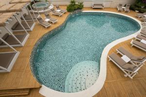 an overhead view of a swimming pool with chairs at Yacht Boheme Hotel-Boutique Class - Adults Only in Fethiye