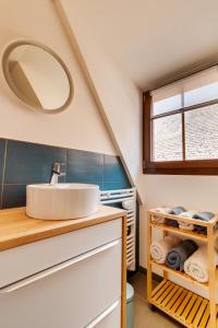 a bathroom with a sink and a mirror at La Grange de Madeleine in Eguisheim