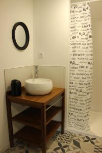 a bathroom with a sink and a mirror at A chacun son nid in Les Épesses +49 photos
