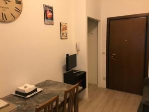 a dining room with a table and a clock on the wall at Portello in Padova