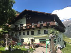 a building with a balcony on top of it at Pension Grünwald in Sölden