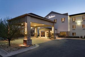 a hotel with a parking lot in front of it at Radisson Hotel Ames Conference Center at ISU in Ames