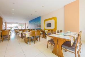 a dining room with wooden tables and chairs at Hosta Otel in Mersin