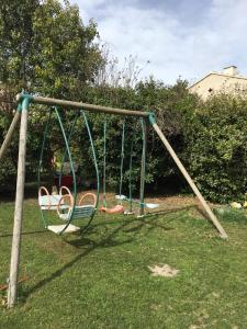 an empty swing set in a yard at Maison de village in Velleron