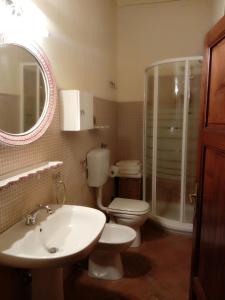 a bathroom with a sink and a toilet and a mirror at Torre rossa in Bolgheri +30 photos