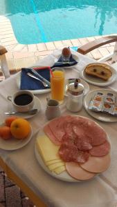 a table with plates of cheese and meat and fruit at Bella Grecia in Hanioti